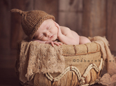 Photo nouveau-ne Photo teintes marron de bébé dans une corbeille
