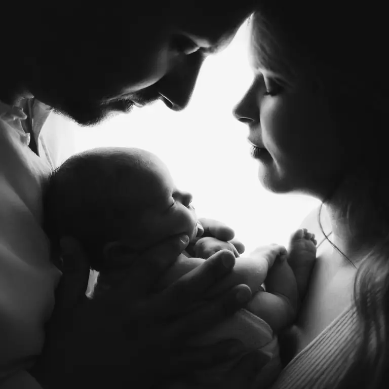Newborn photo session with parents in studio