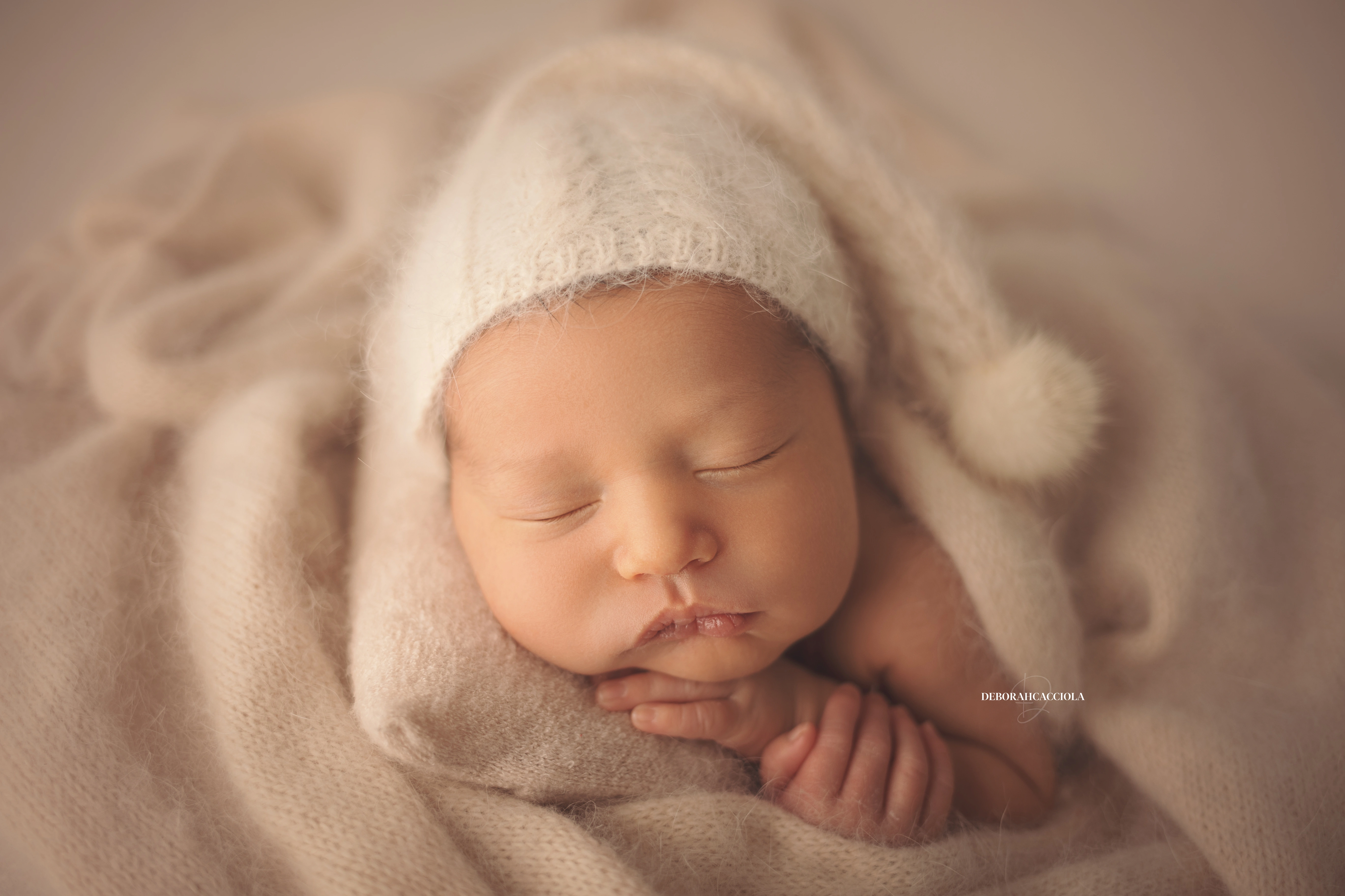 newborn portrait in Orléans, France: baby in the first days, wide natural composition, soft colors