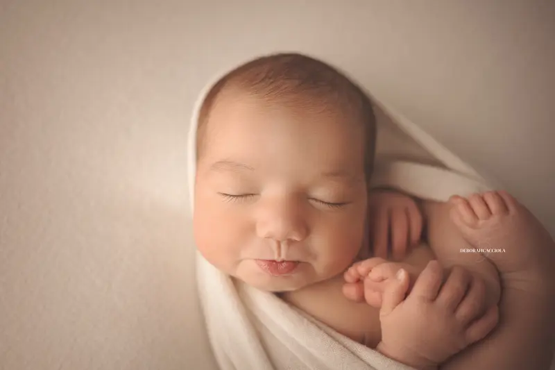 baby session in Orléans, France - tender moment with baby, harmonious wide shot, natural tones