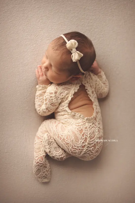 newborn portrait in Orléans, France: tender moment with baby, polished vertical portrait, natural tones
