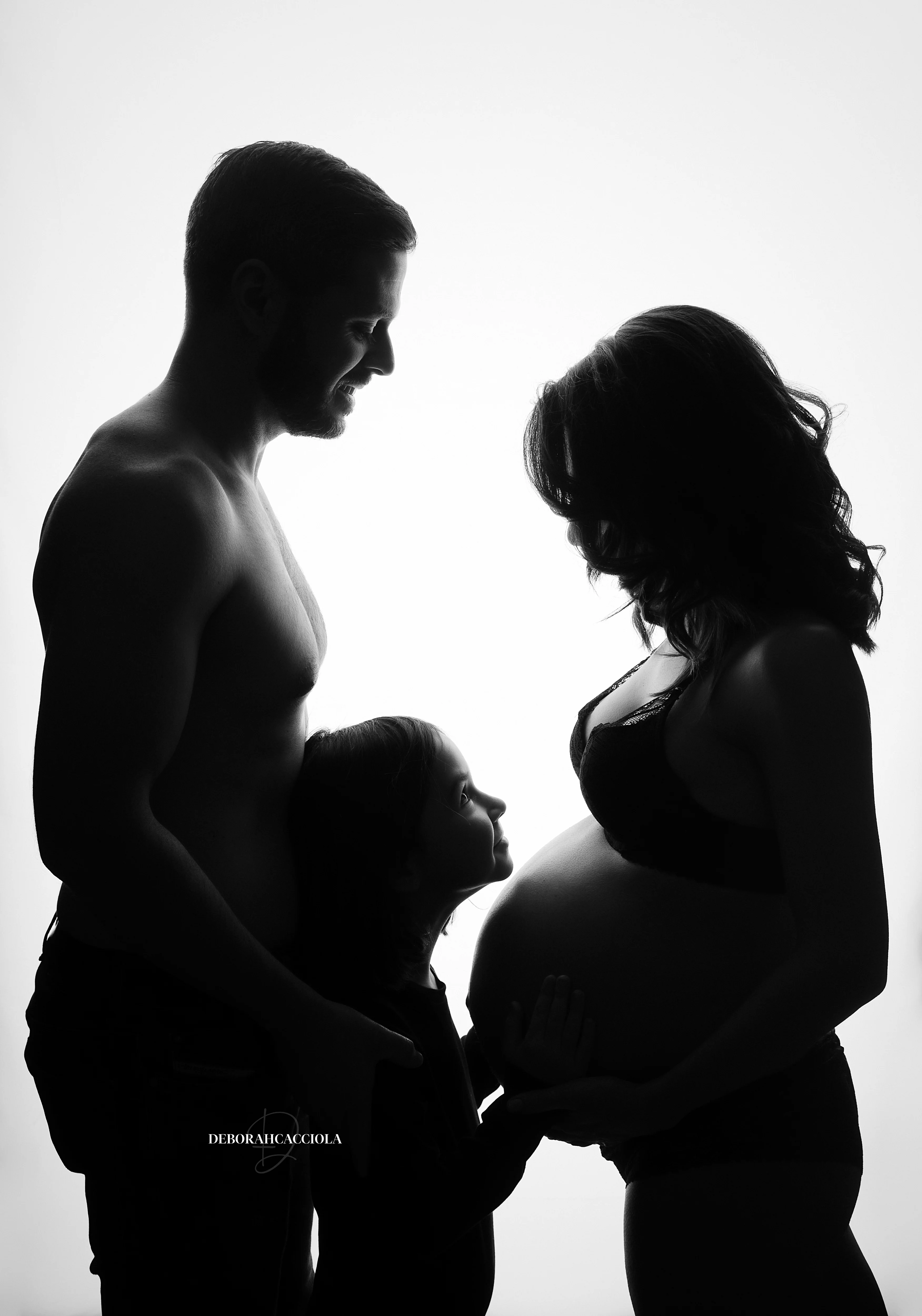 pregnancy portrait in studio in Orléans, France: mother-to-be portrait, soft vertical framing, black-and-white style