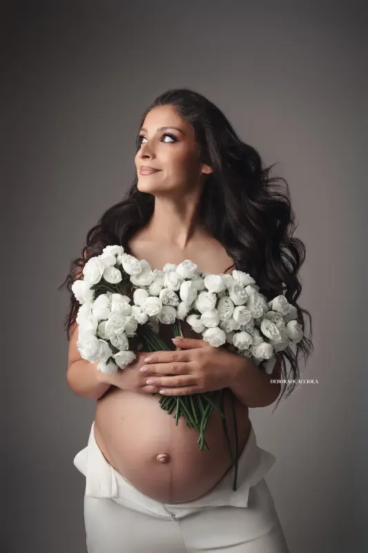 maternity portrait in Orléans, France, mother-to-be during a studio session, soft vertical framing, bright style
