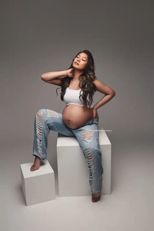 maternity portrait in Orléans, France, mother-to-be during a studio session, soft vertical framing, bright style