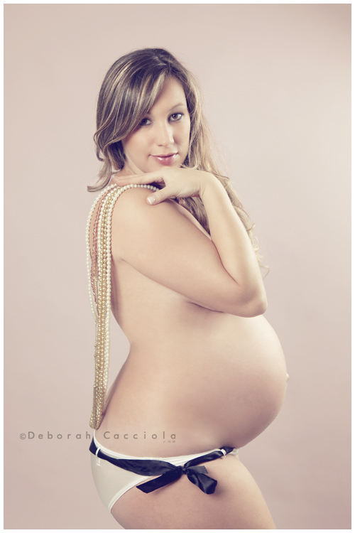 pregnancy portrait in Orléans, France, mother-to-be during a studio session, soft vertical framing, in color