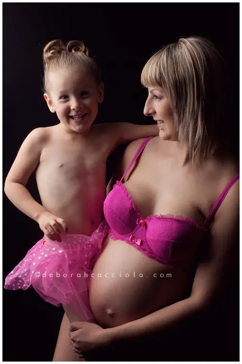 pregnancy portrait in Orléans, France, mother-to-be during a studio session, soft vertical framing, in color
