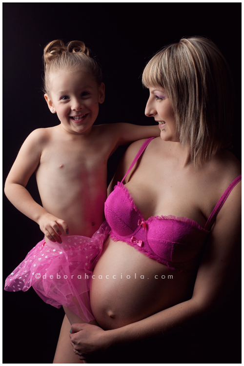 pregnancy portrait in Orléans, France, mother-to-be during a studio session, soft vertical framing, in color