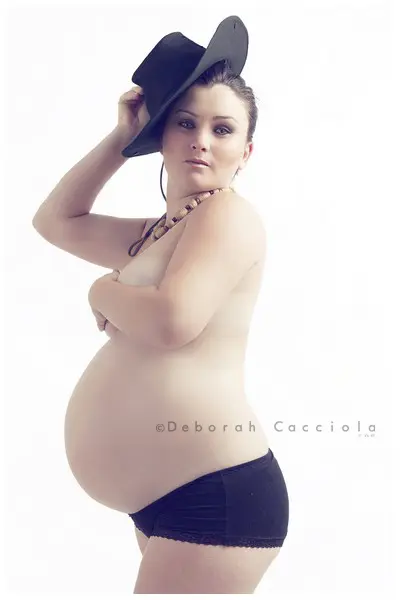 maternity portrait in Orléans, France: mother-to-be during a studio session, soft vertical framing, bright style