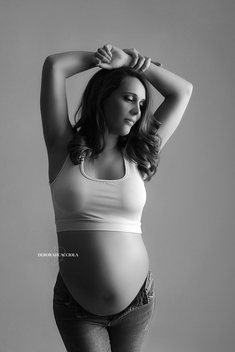 pregnancy portrait in studio in Orléans, France: pregnancy moment, elegant vertical shot, black-and-white style
