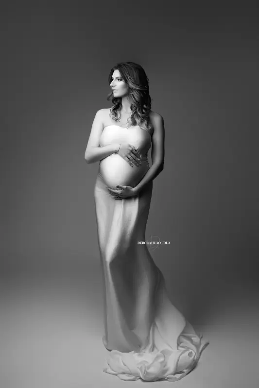 Portrait maternité en studio à Orléans : future maman en séance studio, cadrage vertical doux, style noir et blanc