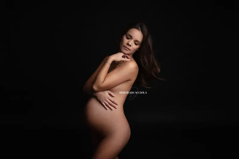 Scène grossesse en studio à Orléans : portrait de future maman, plan large harmonieux, style noir et blanc