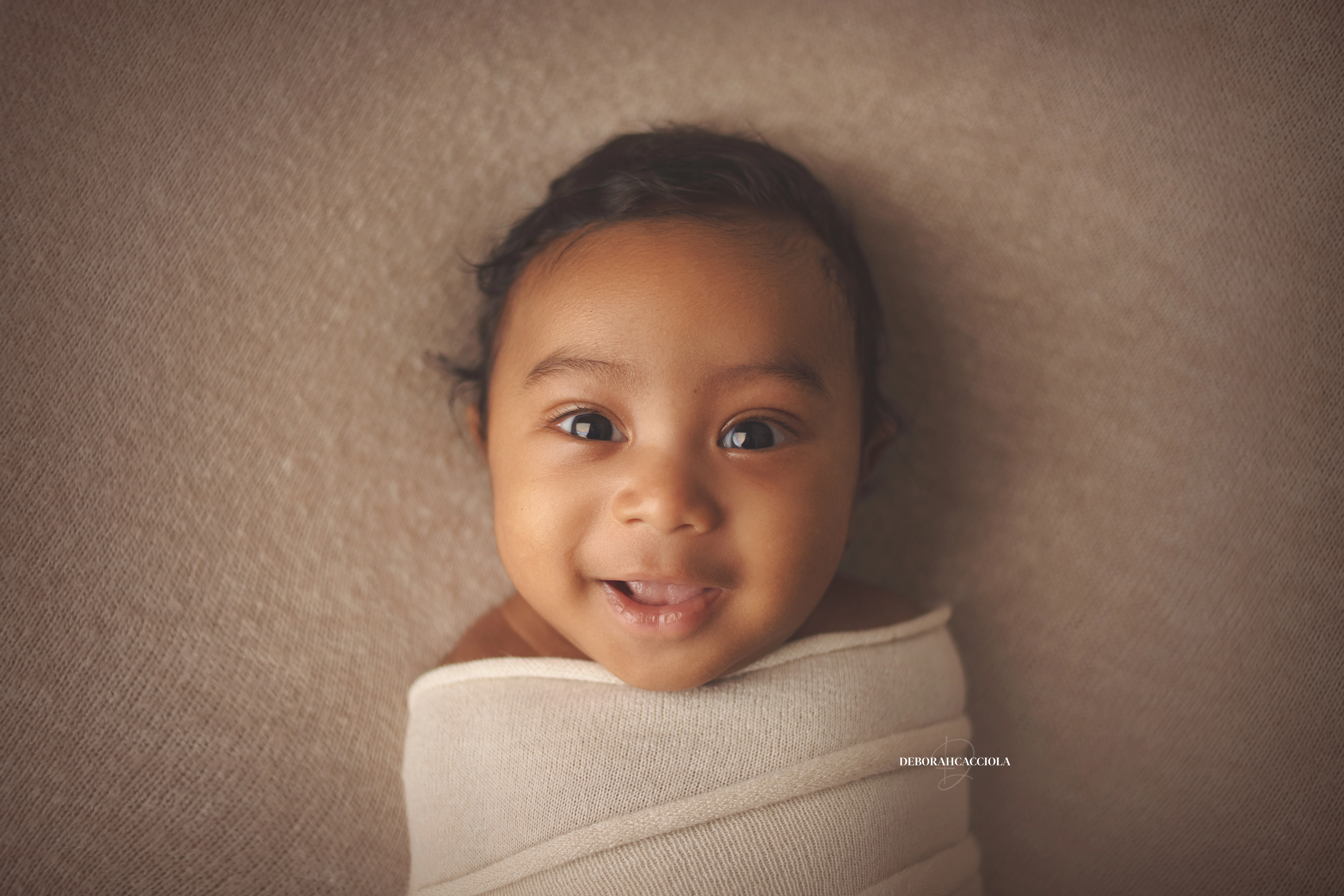 Portrait nouveau-né à Orléans : bébé dans ses premiers jours, composition large et naturelle, palette claire