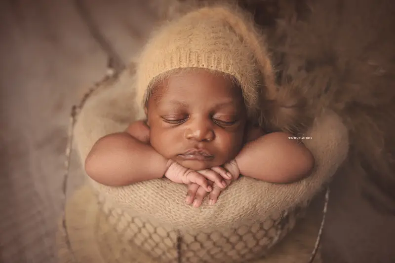 Portrait nouveau-né à Orléans : instant tendre avec bébé, plan large harmonieux, rendu naturel