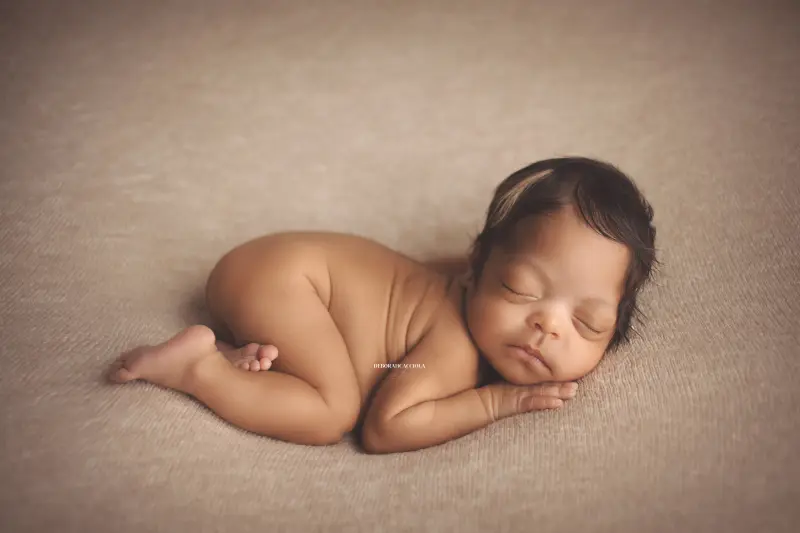 Séance bébé en studio à Orléans : portrait délicat de bébé, cadrage horizontal équilibré, rendu naturel