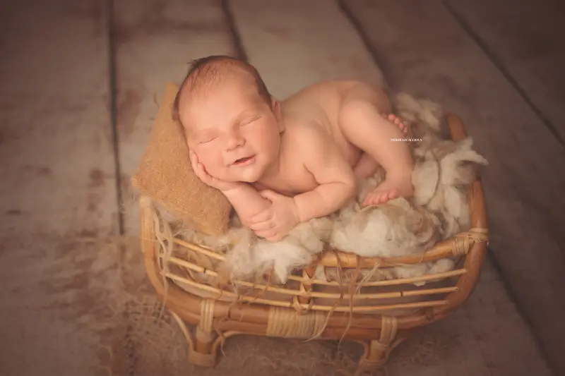 Portrait nouveau-né à Orléans : instant tendre avec bébé, plan large harmonieux, couleurs équilibrées