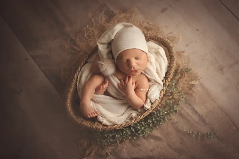 Photo nouveau-né studio Orléans : nouveau-né en studio, scène panoramique douce, couleurs douces
